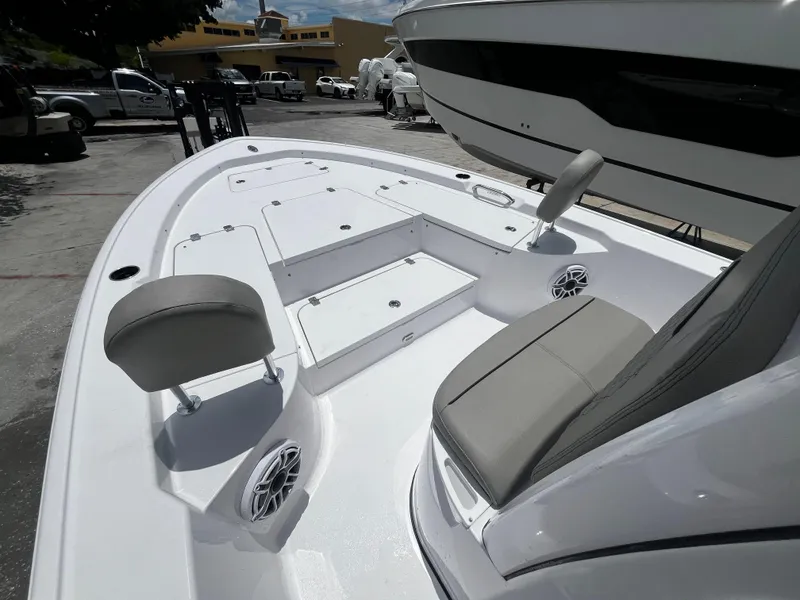 Slide: The Image of 2025 Sportsman Masters 227 Bay Boat interior with seating and storage compartments. - 18