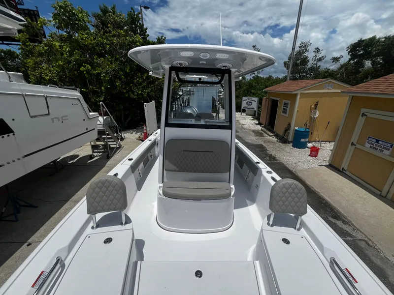 Slide: The Image of 2025 Sportsman Masters 227 Bay Boat docked, showcasing spacious deck and seating. - 19