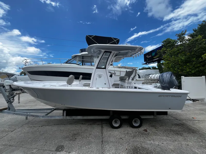 Slide: The Image of 2025 Sportsman Masters 227 Bay Boat on trailer, side view, under blue sky. - 6