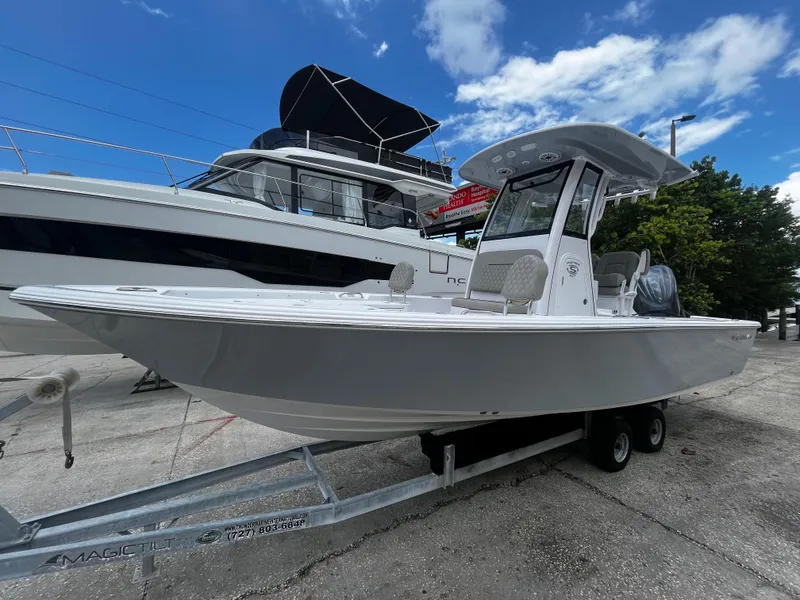 Slide: The Image of 2025 Sportsman Masters 227 Bay Boat on trailer, docked at marina. - 7