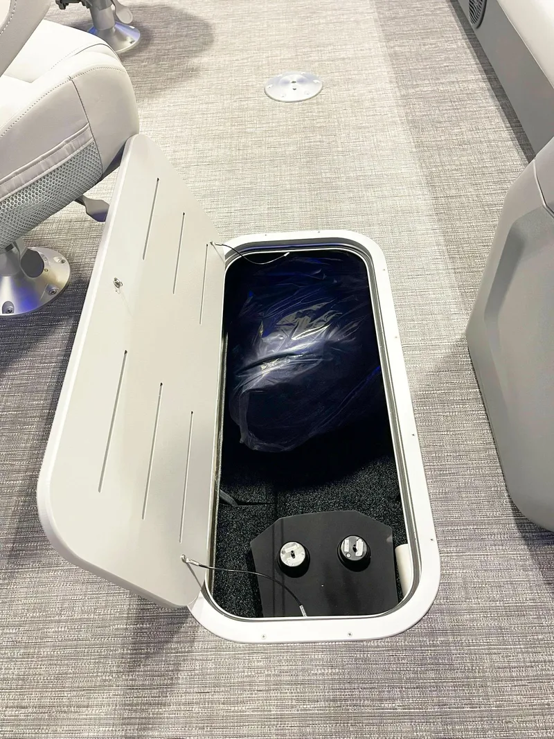 Slide: The Image of Bennington 20S 2025 model boat storage compartment with open hatch. - 13