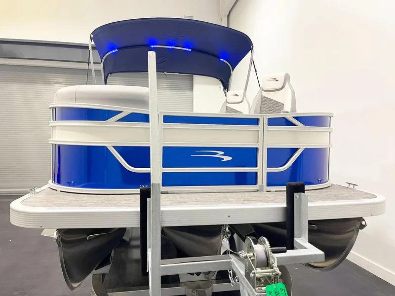Slide: The Image of 2025 Bennington 20S pontoon boat with blue exterior and canopy in showroom. - 3