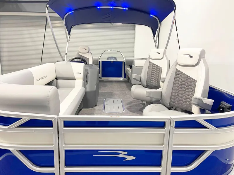 Slide: The Image of 2025 Bennington 20S pontoon boat with blue and white interior, canopy, and comfortable seating. - 4