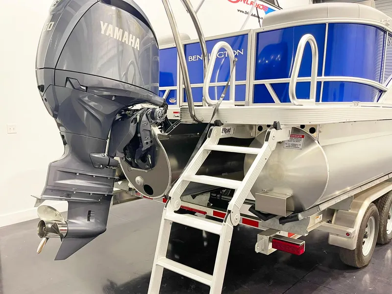 Slide: The Image of 2025 Bennington 20S pontoon boat with Yamaha outboard motor and boarding ladder. - 6