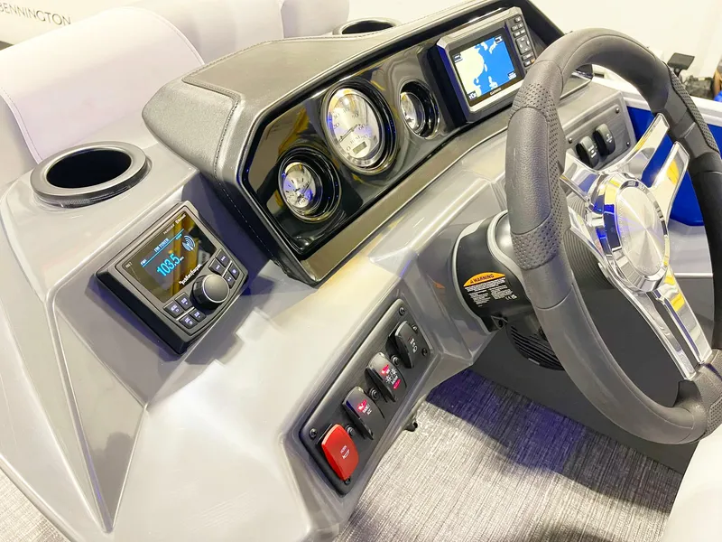 Slide: The Image of 2025 Bennington 20S boat dashboard with steering wheel, gauges, and navigation system. - 7