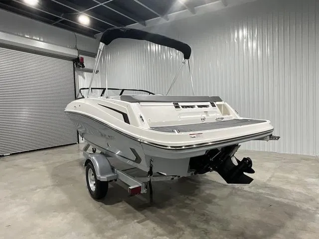 Slide: The Image of 2024 Bayliner VR5 Bowrider boat in a showroom, rear view. - 9