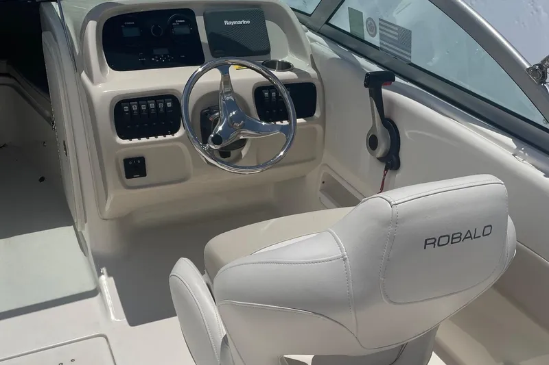 Slide: The Image of 2015 Robalo R227 Dual Console boat interior with steering wheel and controls. - 5