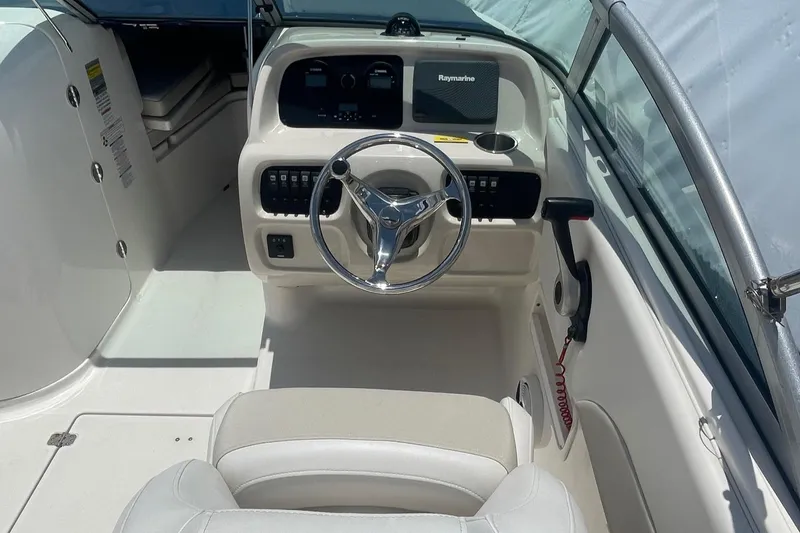 Slide: The Image of 2015 Robalo R227 Dual Console boat interior with steering wheel and dashboard. - 7