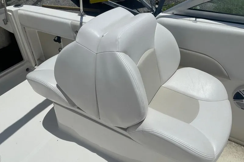 Slide: The Image of 2015 Robalo R227 Dual Console boat with white leather seating. - 9