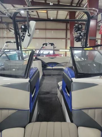 Slide: The Image of 2015 Malibu 247 LSV boat interior with seating and wakeboard tower. - 10