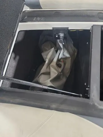 Slide: The Image of 2015 Malibu 247 LSV storage compartment with gray cover. - 11