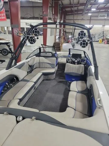 Slide: The Image of 2015 Malibu 247 LSV boat interior with spacious seating and audio system. - 3