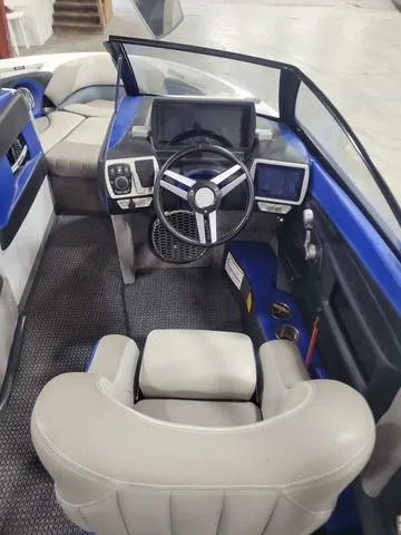 Slide: The Image of 2015 Malibu 247 LSV boat interior with modern dashboard and steering wheel. - 6