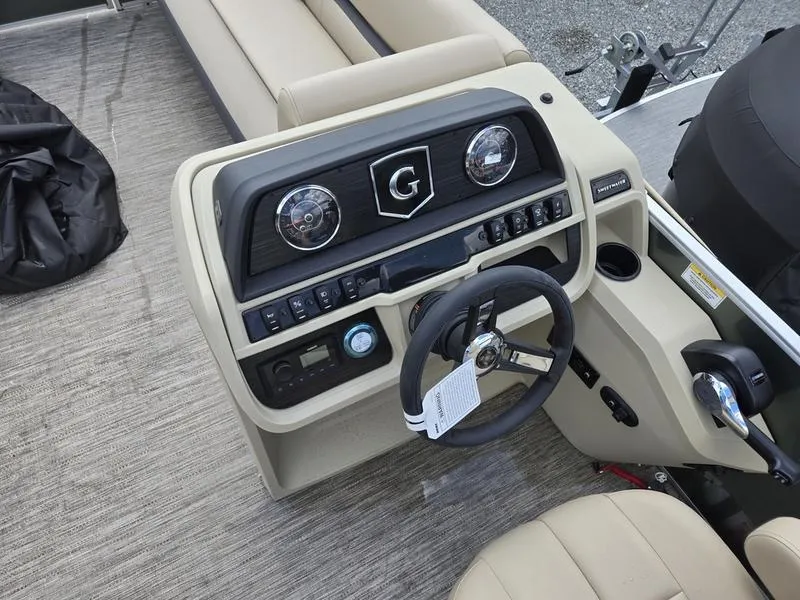Slide: The Image of 2024 Godfrey Sweetwater 2086 C pontoon boat interior with beige seating and cupholder table. - 11