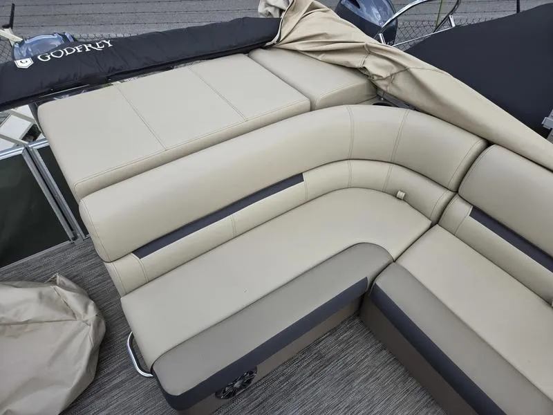 Slide: The Image of 2024 Godfrey Sweetwater 2086 C boat dashboard with steering wheel and control panel. - 12