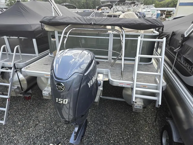 Slide: The Image of 2024 Godfrey Sweetwater 2086 C pontoon boat on trailer, parked on grass. - 4