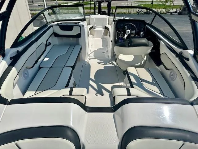 Slide: The Image of 2017 Yamaha Boats AR210 interior with spacious seating and modern dashboard. - 4