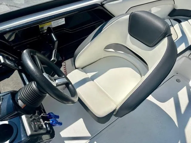 Slide: The Image of 2017 Yamaha Boats AR210 cockpit with steering wheel and captain's seat. - 5