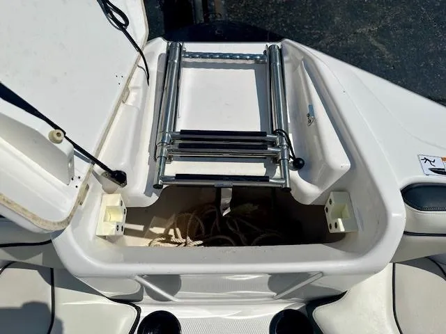 Slide: The Image of 2017 Yamaha Boats AR210 storage compartment with ladder and rope. - 8