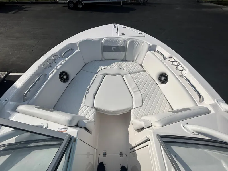 Slide: The Image of 2025 Sea Fox 228 Traveler boat interior with white cushioned seating and cup holders. - 15