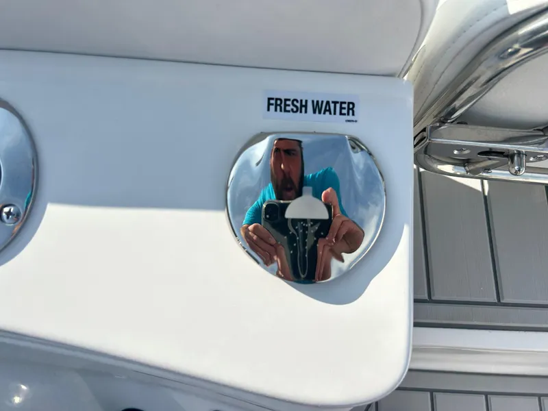 Slide: The Image of Sea Fox 228 Traveler 2025 boat fresh water access panel with reflection. - 17