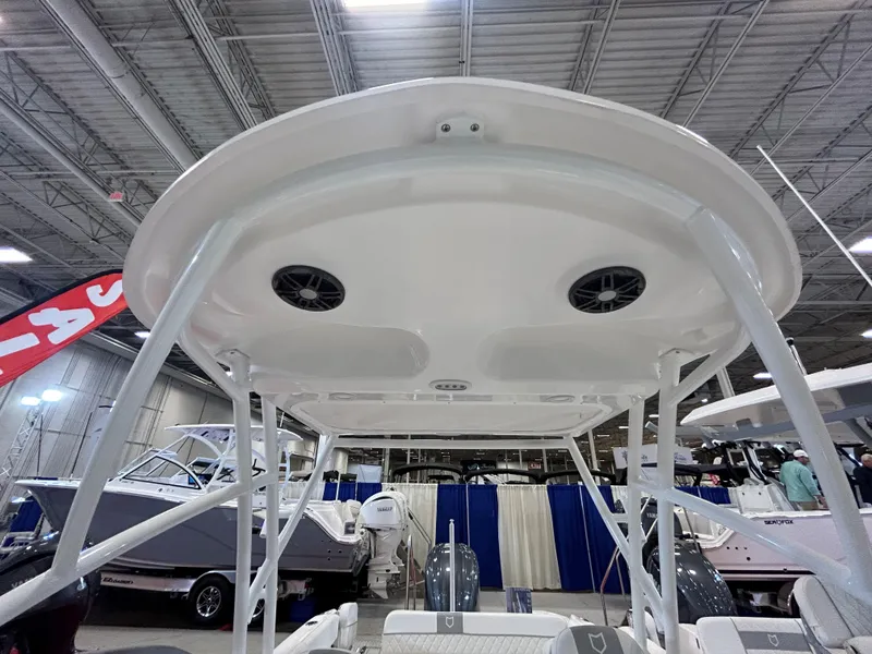 Slide: The Image of 2025 Sea Fox 228 Traveler boat canopy with speakers, displayed indoors. - 21