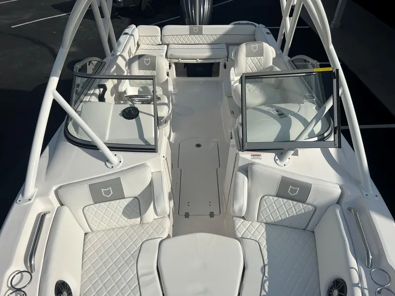 Slide: The Image of 2025 Sea Fox 228 Traveler boat interior with white quilted seating and dual consoles. - 26