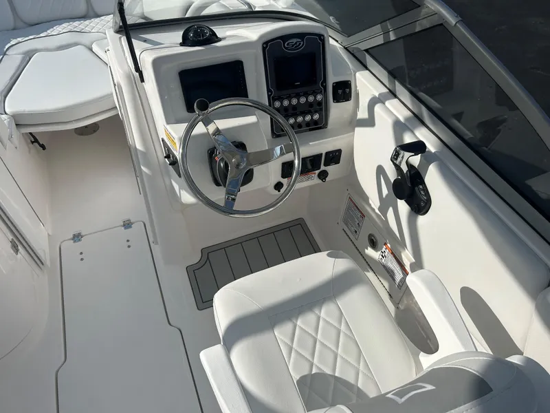Slide: The Image of 2025 Sea Fox 228 Traveler boat cockpit with steering wheel and control panel. - 28