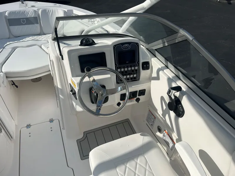 Slide: The Image of 2025 Sea Fox 228 Traveler boat cockpit with steering wheel and dashboard controls. - 29