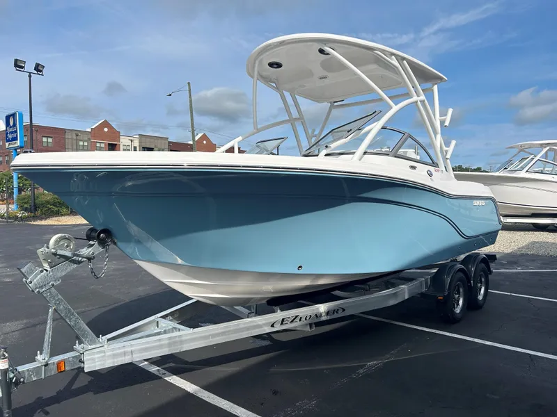 Slide: The Image of 2025 Sea Fox 228 Traveler boat on trailer, light blue hull, parked outdoors. - 4