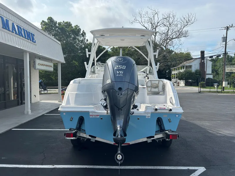Slide: The Image of 2025 Sea Fox 228 Traveler boat with Yamaha 250 V6 engine, parked outside a marine shop. - 5