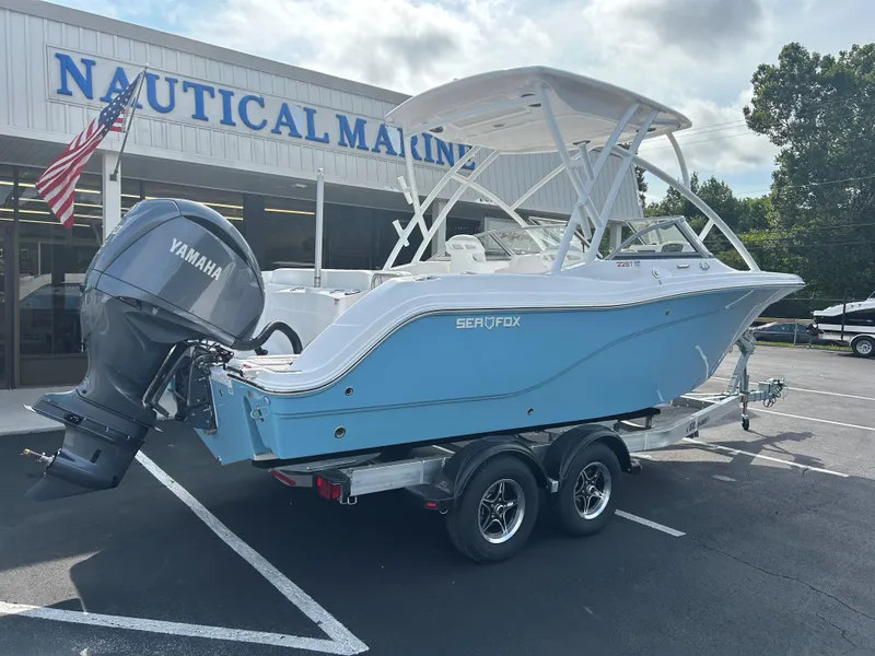 Slide: The Image of 2025 Sea Fox 228 Traveler boat on trailer at dealership, featuring Yamaha outboard motor. - 7