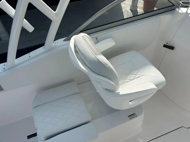 Slide: The Image of 2025 Sea Fox 228 Traveler boat interior with white cushioned seating. - 9