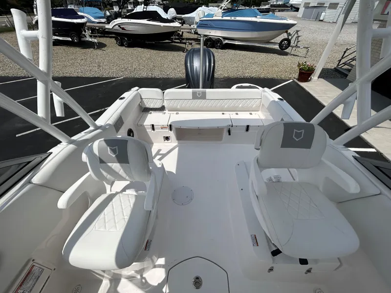 Slide: The Image of 2025 Sea Fox 228 Traveler boat interior with white seating and spacious deck. - 14