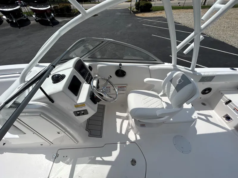 Slide: The Image of 2025 Sea Fox 228 Traveler boat cockpit with steering wheel and seating. - 15