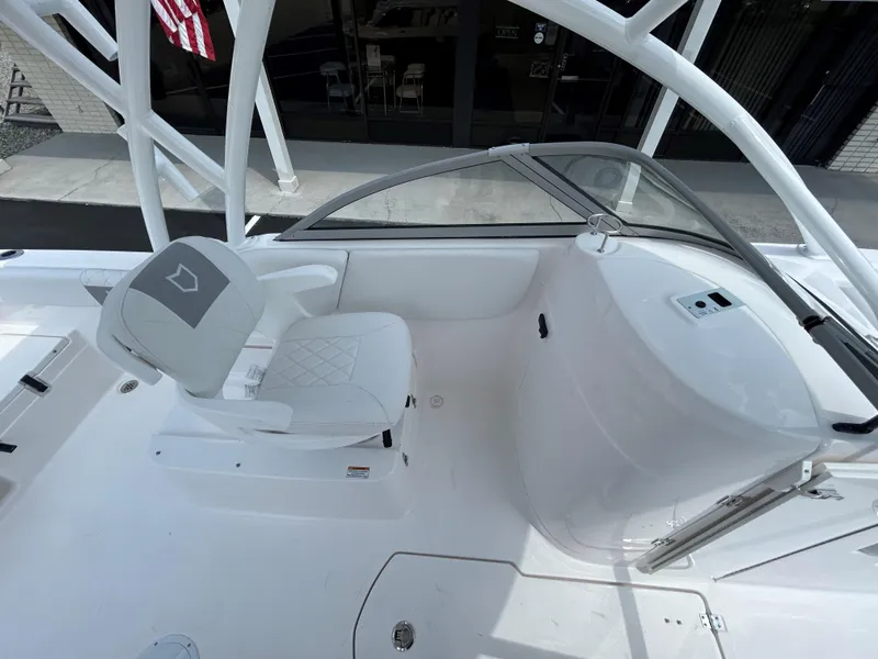 Slide: The Image of 2025 Sea Fox 228 Traveler boat interior with white seating and console. - 16