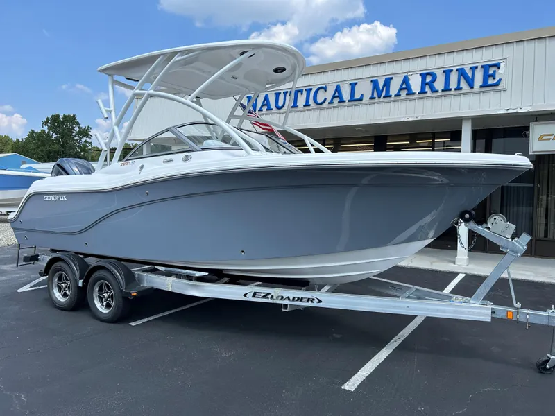 Slide: The Image of 2025 Sea Fox 228 Traveler boat on trailer outside Nautical Marine store. - 5