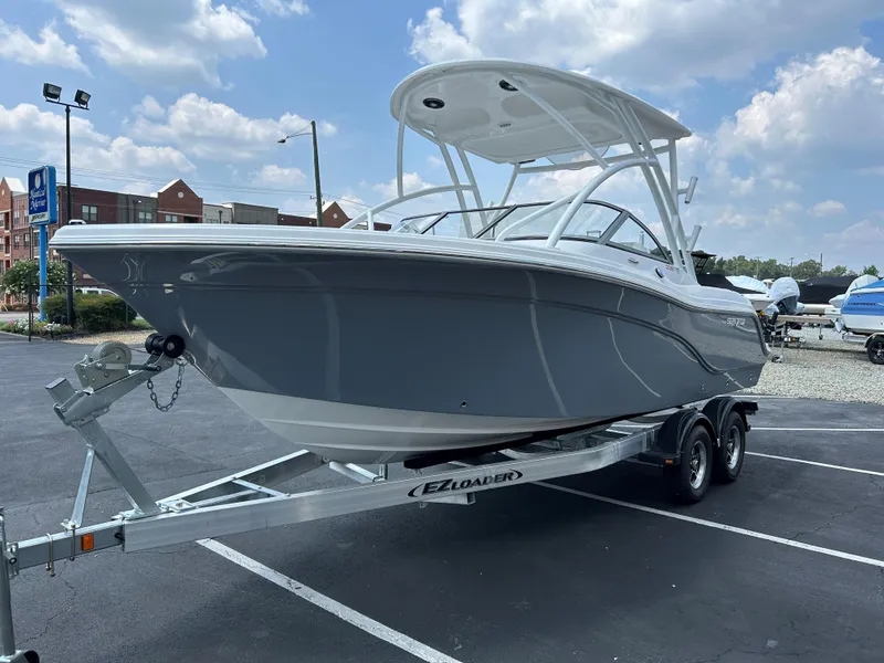 Slide: The Image of 2025 Sea Fox 228 Traveler boat on trailer in parking lot under blue sky. - 7