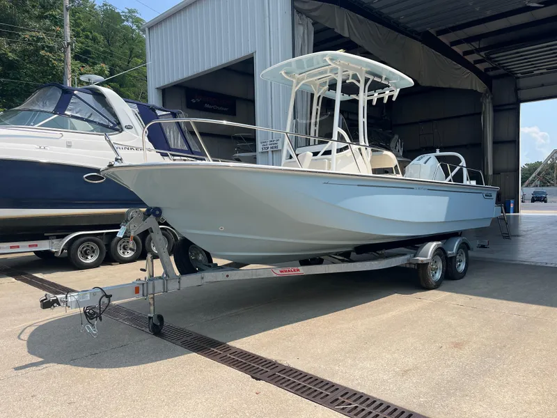 The Image of 2024 Boston Whaler 210 Montauk on a trailer outside a boat storage facility. - 0