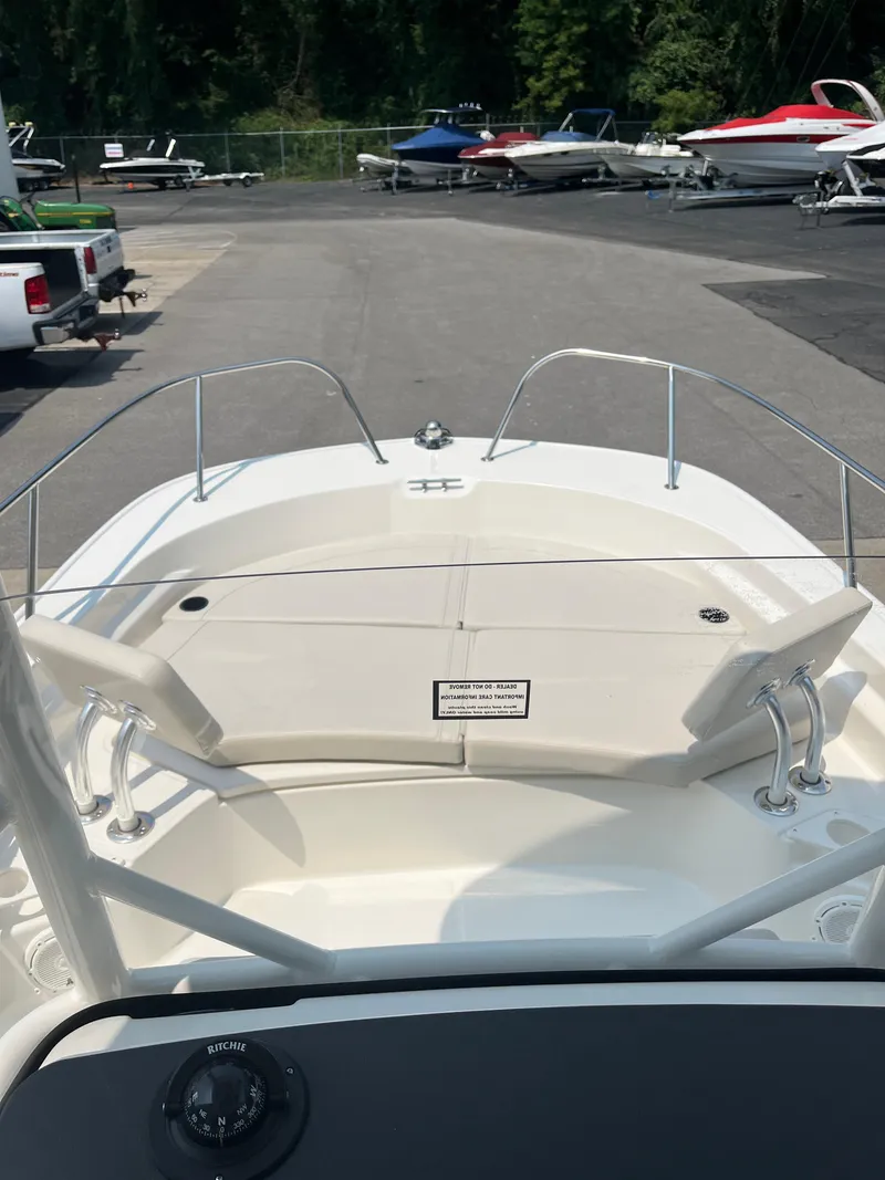 Slide: The Image of 2024 Boston Whaler 210 Montauk boat bow view at a marina. - 3