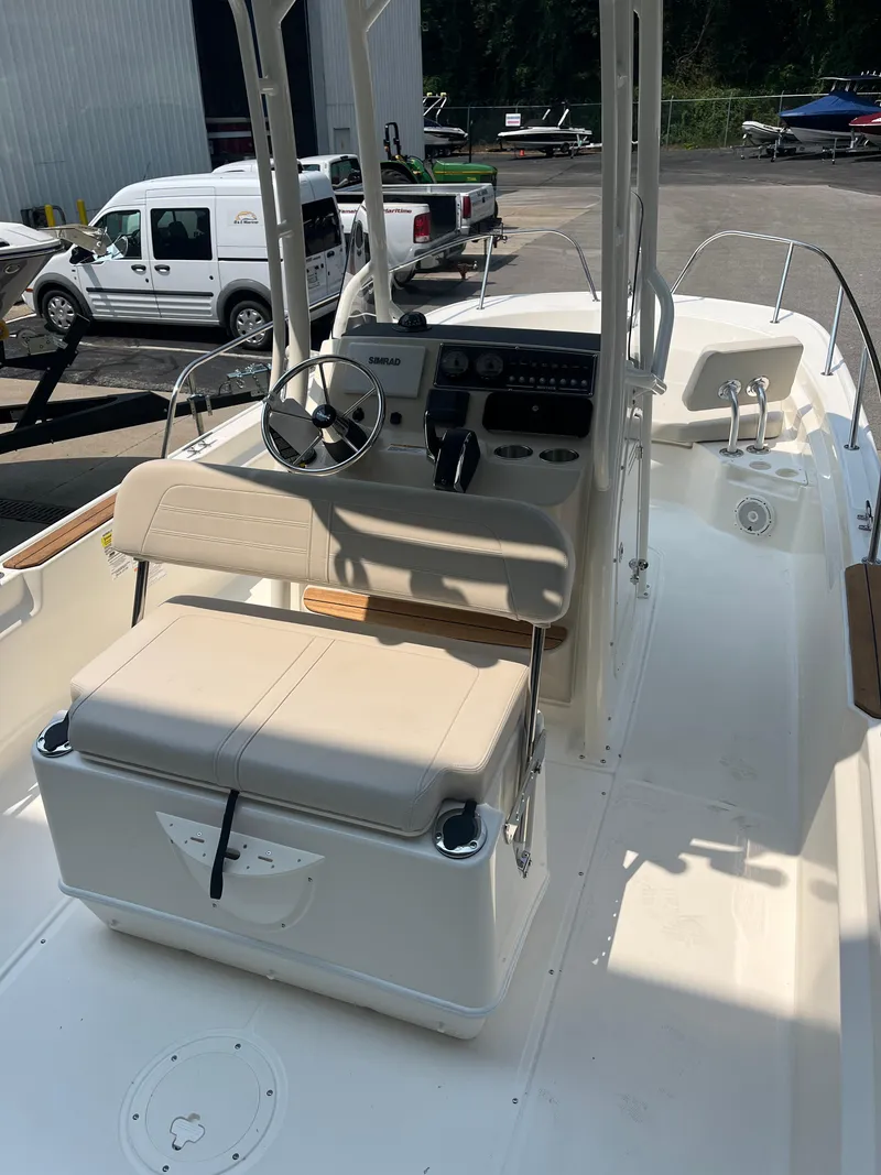 Slide: The Image of 2024 Boston Whaler 210 Montauk boat interior with helm and seating. - 5