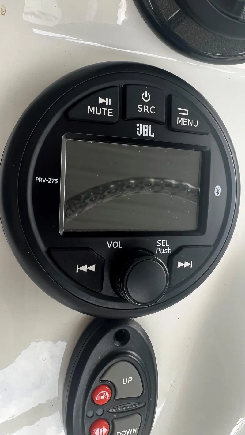 Slide: The Image of JBL PRV-275 audio system and control panel on 2023 Excel 220 Bay Pro boat. - 10