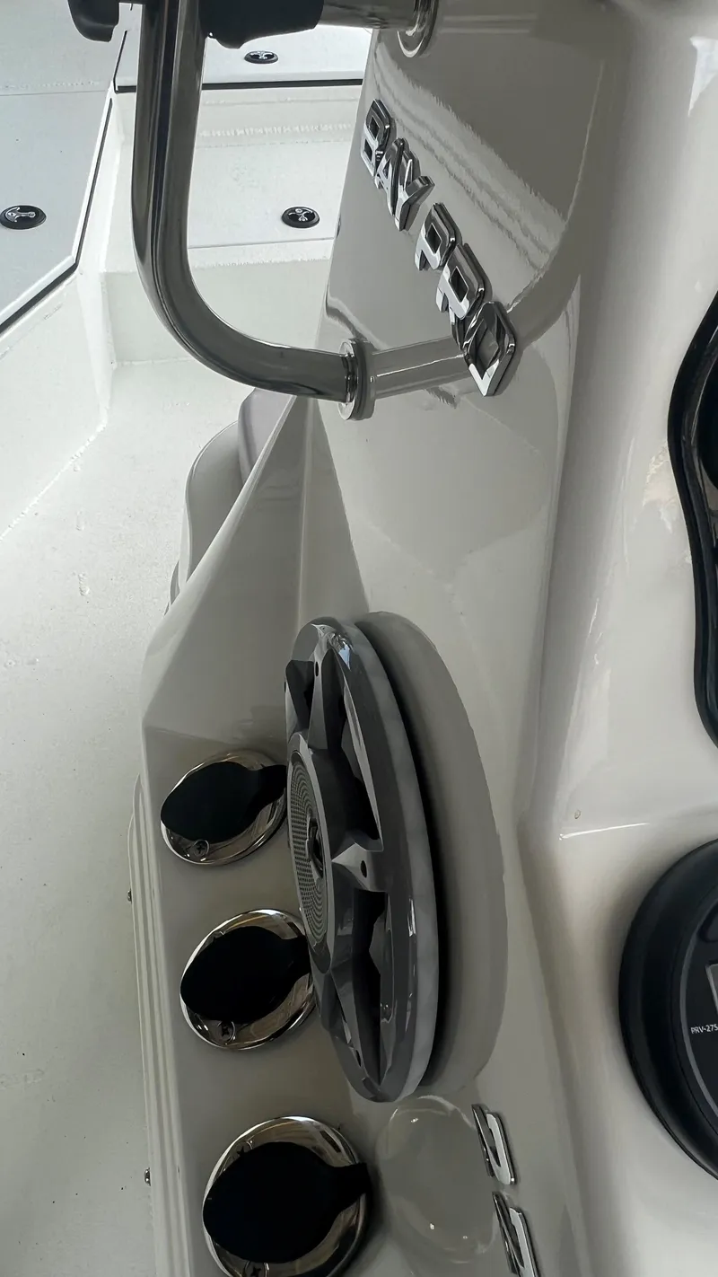 Slide: The Image of Close-up of 2023 Excel 220 Bay Pro boat console with speaker and cup holders. - 11