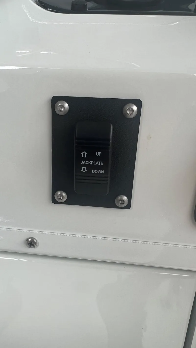 Slide: The Image of 2023 Excel 220 Bay Pro jackplate control switch on white panel. - 13