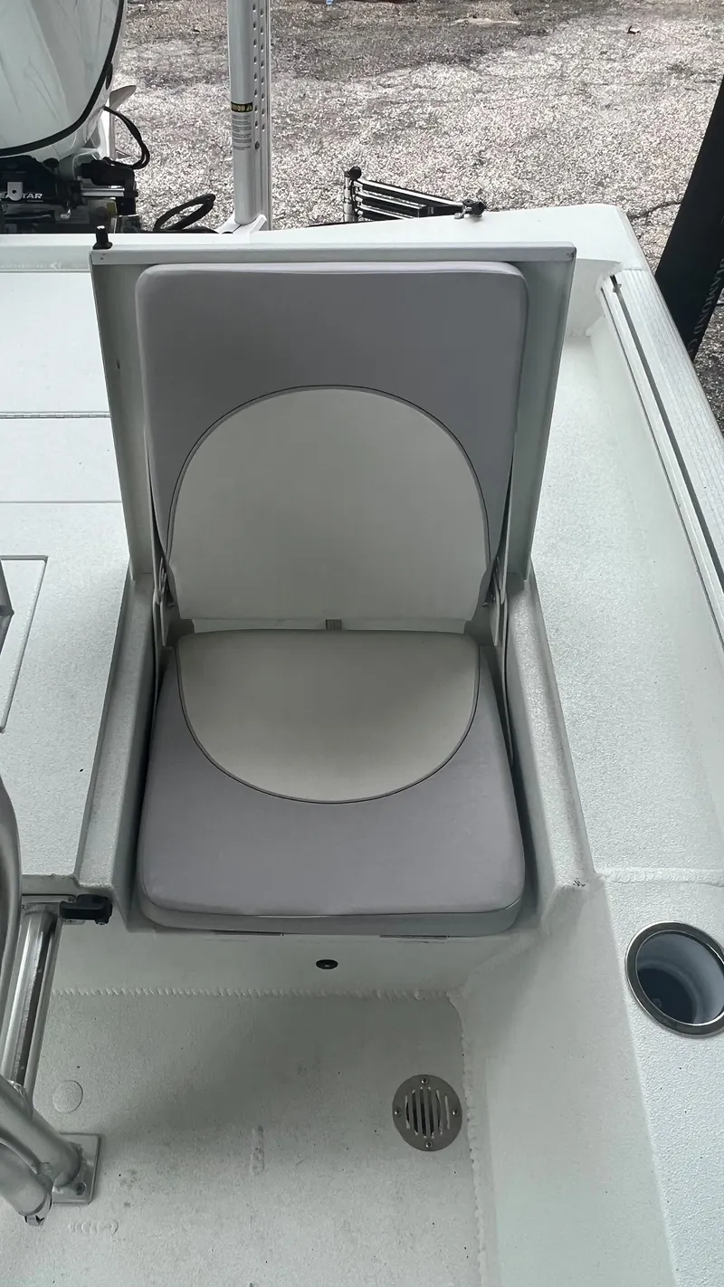 Slide: The Image of 2023 Excel 220 Bay Pro boat seat with gray cushion and storage compartment. - 15