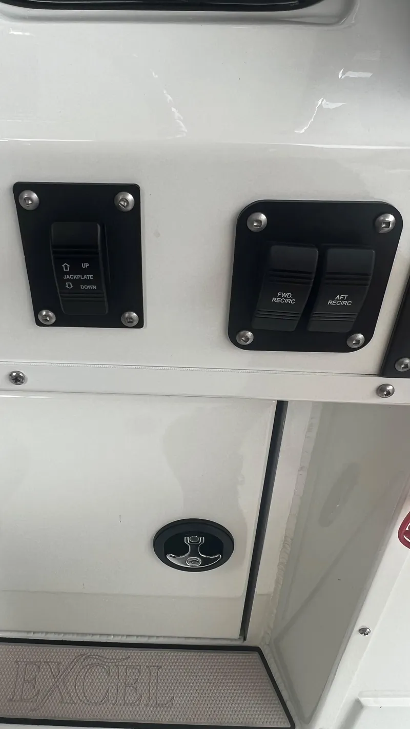 Slide: The Image of Control panel of a 2023 Excel 220 Bay Pro boat with jackplate and recirculation switches. - 17