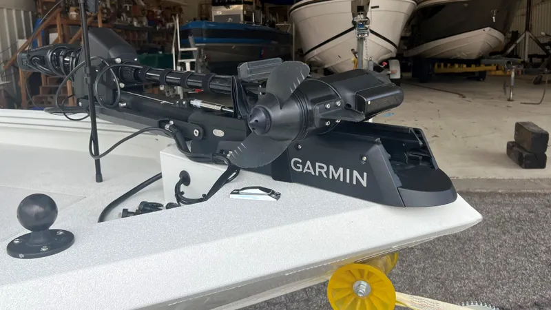 Slide: The Image of 2023 Excel 220 Bay Pro boat with Garmin trolling motor in a storage facility. - 21