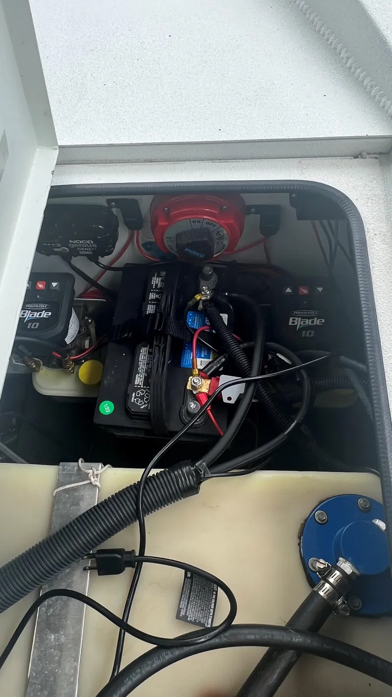Slide: The Image of Battery compartment of a 2023 Excel 220 Bay Pro boat with wiring and components. - 23