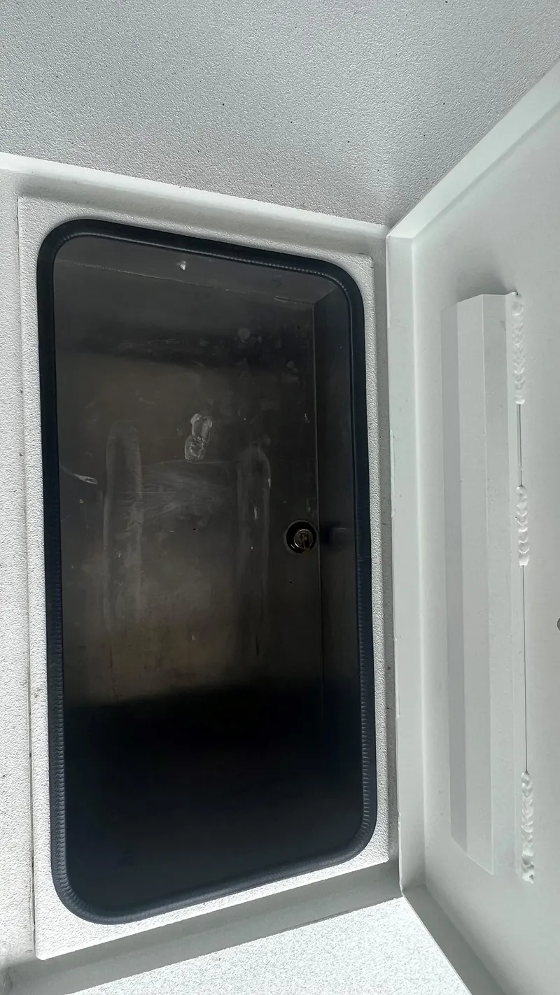 Slide: The Image of 2023 Excel 220 Bay Pro storage compartment with black interior. - 24