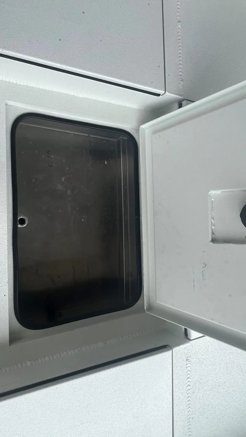 Slide: The Image of Open storage compartment on a 2023 Excel 220 Bay Pro boat. - 25